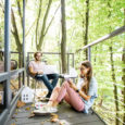 Creative couple of architects working outdoors at the forest house