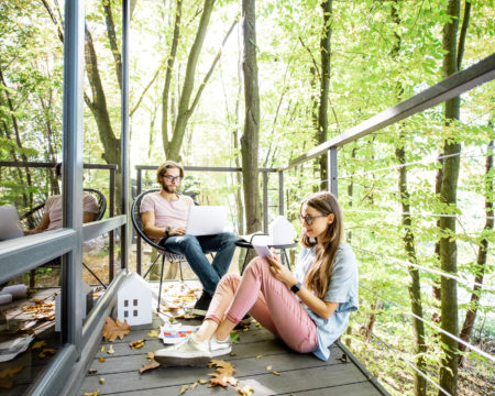 Creative couple of architects working outdoors at the forest house