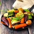 Skillet of roasted vegetables against rustic wood