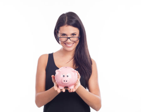 Young woman with glasses happy with piggy bank