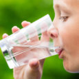 Child drinking glass of fresh water