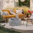 Real photo of an armchair, pouf as a table and wicker couch on a terrace