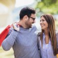 Young couple with shopping bags and credit card in the city