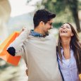 Young couple with shopping bags and credit card in the city