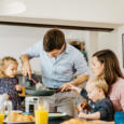 Father serving breakfast to family