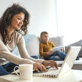 Busy young woman with son at home.