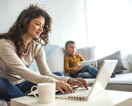 Busy young woman with son at home.