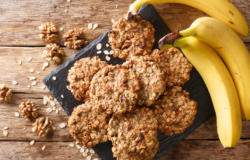 Homemade low-calorie banana cookies with oatmeal and walnuts close-up on a slate board. Horizontal top view