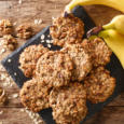 Homemade low-calorie banana cookies with oatmeal and walnuts close-up on a slate board. Horizontal top view