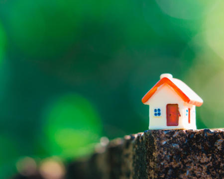 Closeup miniature house on green nature background