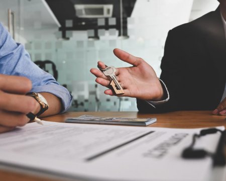 Cropped image of Real estate agent offer house insurance or house ownership to smart man in blue shirt