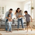 Happy family playing funny game having fun together.