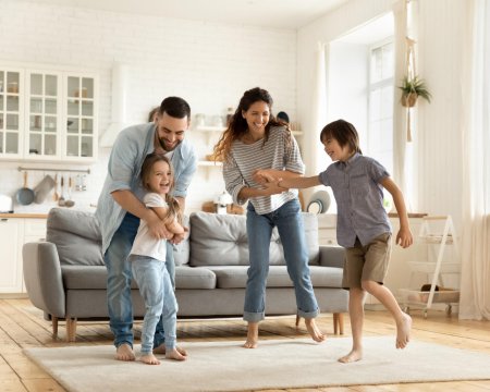 Happy family playing funny game having fun together.